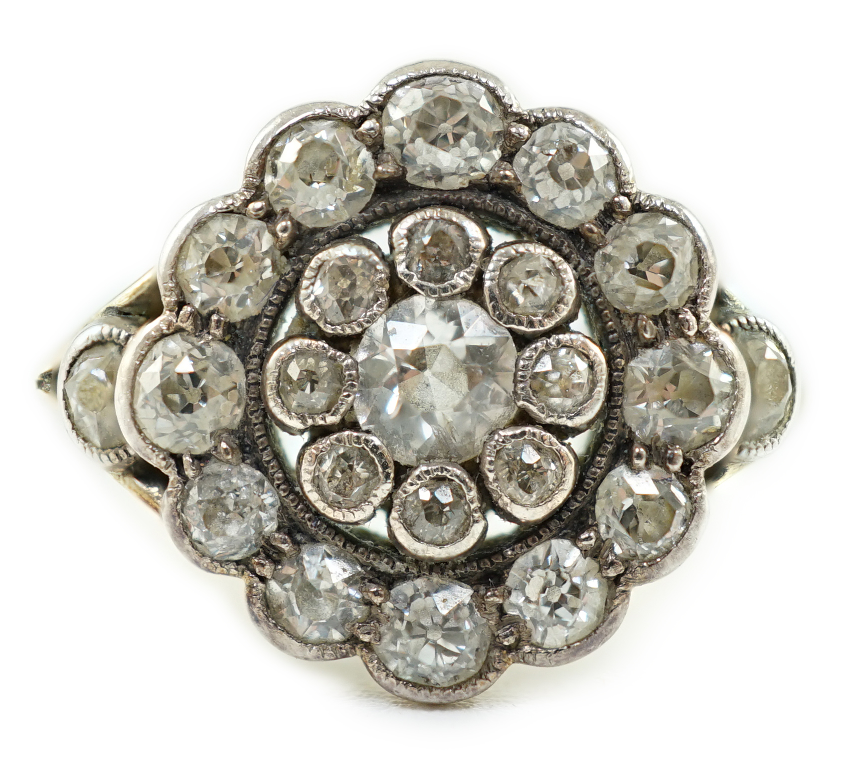 A mid 20th century gold and millegrain set diamond cluster target ring